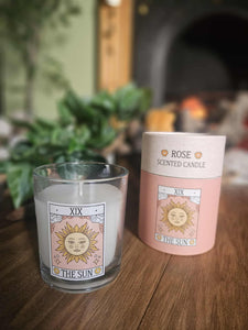 Rose scented candle with 'The Sun' design on a wooden surface

www.karmaripon.co.uk