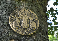 Load image into Gallery viewer, Decorative plaque with rabbit design hanging on a tree. www.karmaripon.co.uk