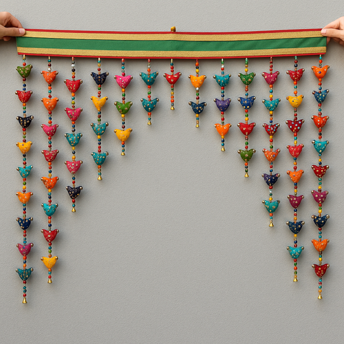 Colourful hanging decorative item with beads and small figures on a grey background www.karmaripon.co.uk