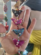 Load image into Gallery viewer, Colourful hanging decorative item with beads and small figures on a grey background www.karmaripon.co.uk