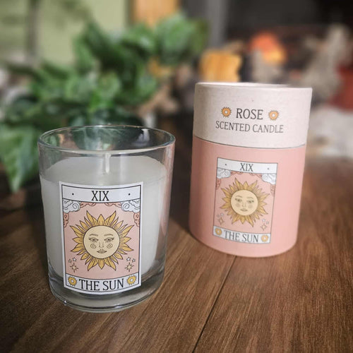 Rose scented candle with 'The Sun' design on a wooden surface

www.karmaripon.co.uk